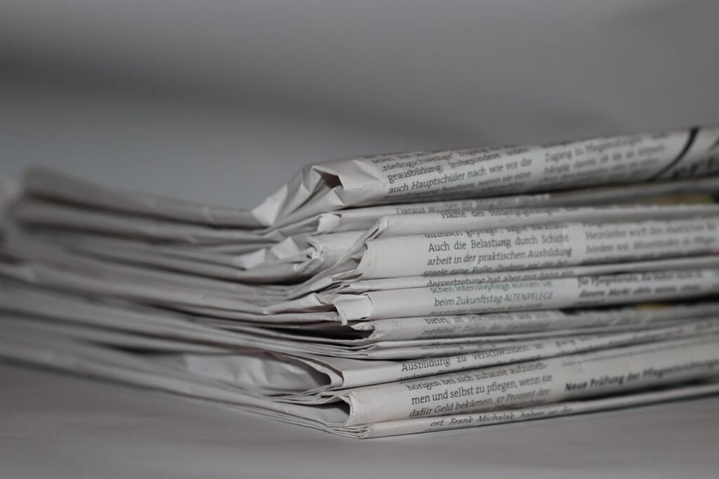 A close-up image of folded newspapers, perfect for news or journalism themes.
